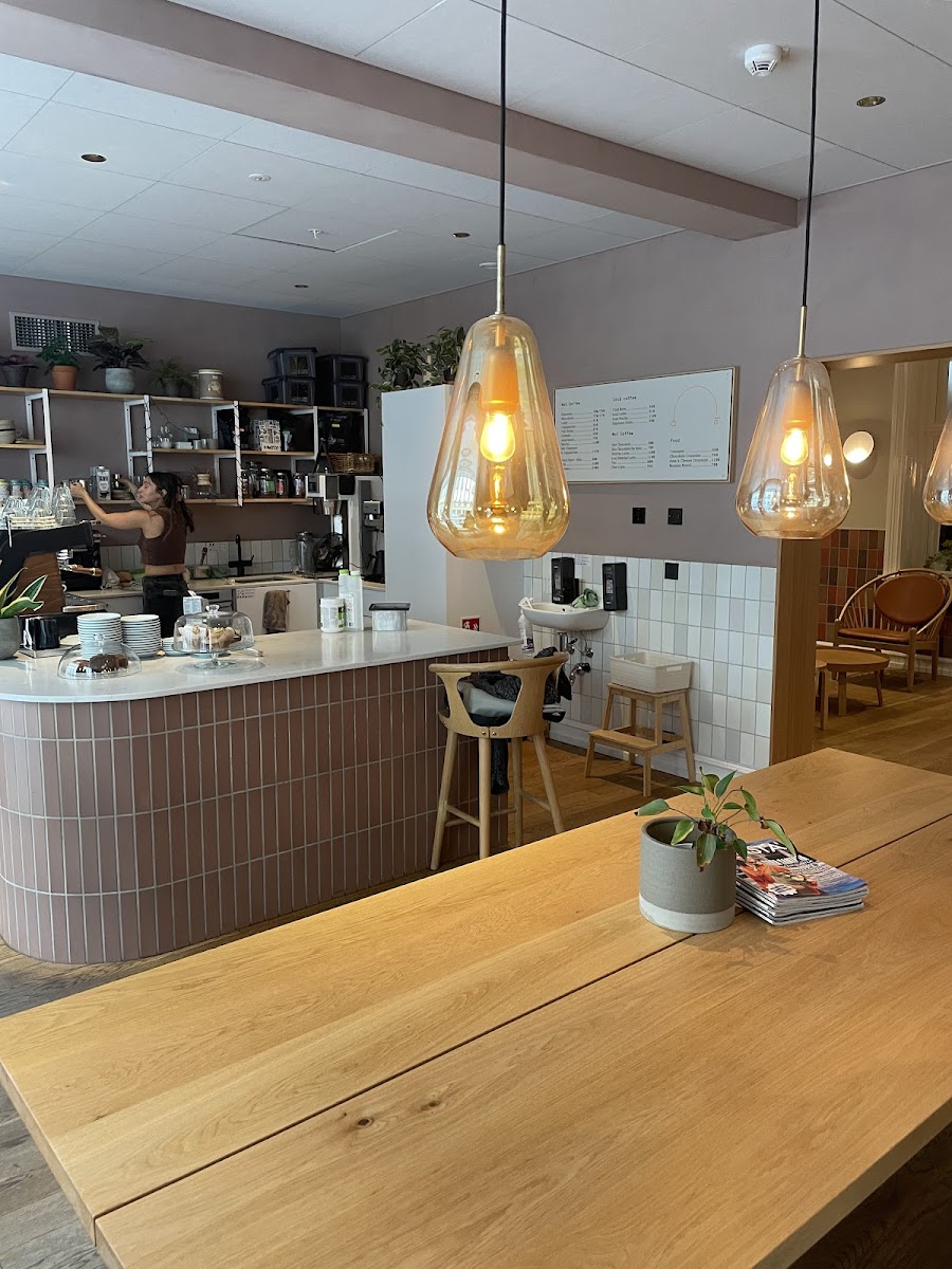 Inside Kaffi Ó-le — terracotta tile bar and oak tables